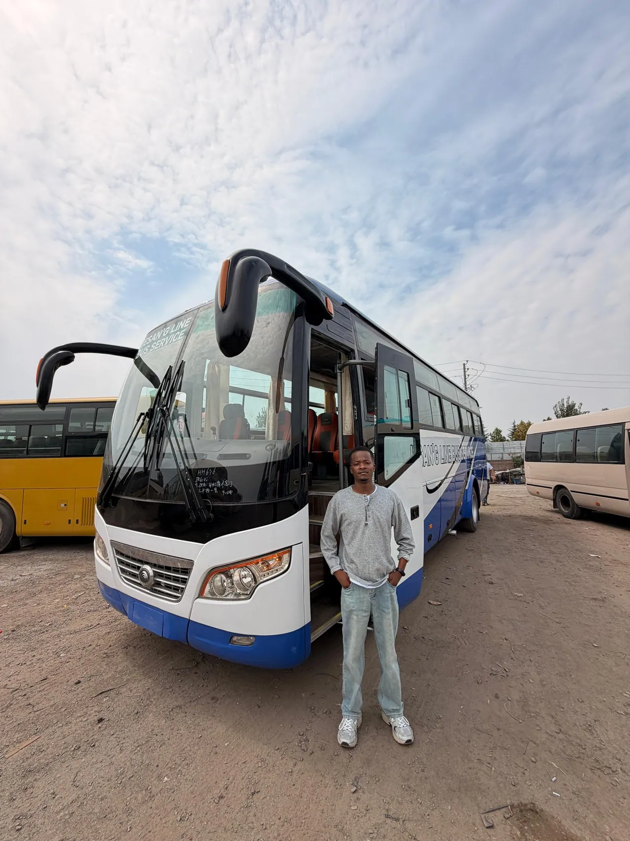 LinkChinaToTZ Motors staff inspecting a coach before shipment