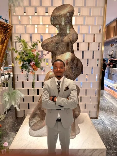 A LinkChinaToTZ representative in a supplier building lobby